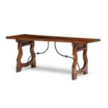 A Spanish wrought-iron and walnut trestle table, 18th century the rectangular top raised on scroll