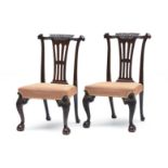 A pair of George III style mahogany side chairs, early 20th century each with curved top-rail carved