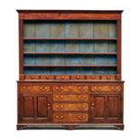 A Welsh oak dresser, circa 1847 the superstructure with three shelves above six small drawers,