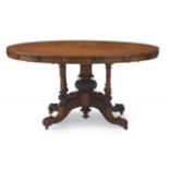 A Victorian burr-walnut and walnut centre table the circular tilt-top above a freize carved with