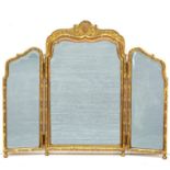 A George I style carved gilt gesso three-fold mirror the central arched mirror with shell and