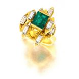 Emerald and diamond ring set with an emerald-cut emerald weighing approximately 1.30 carats, flanked