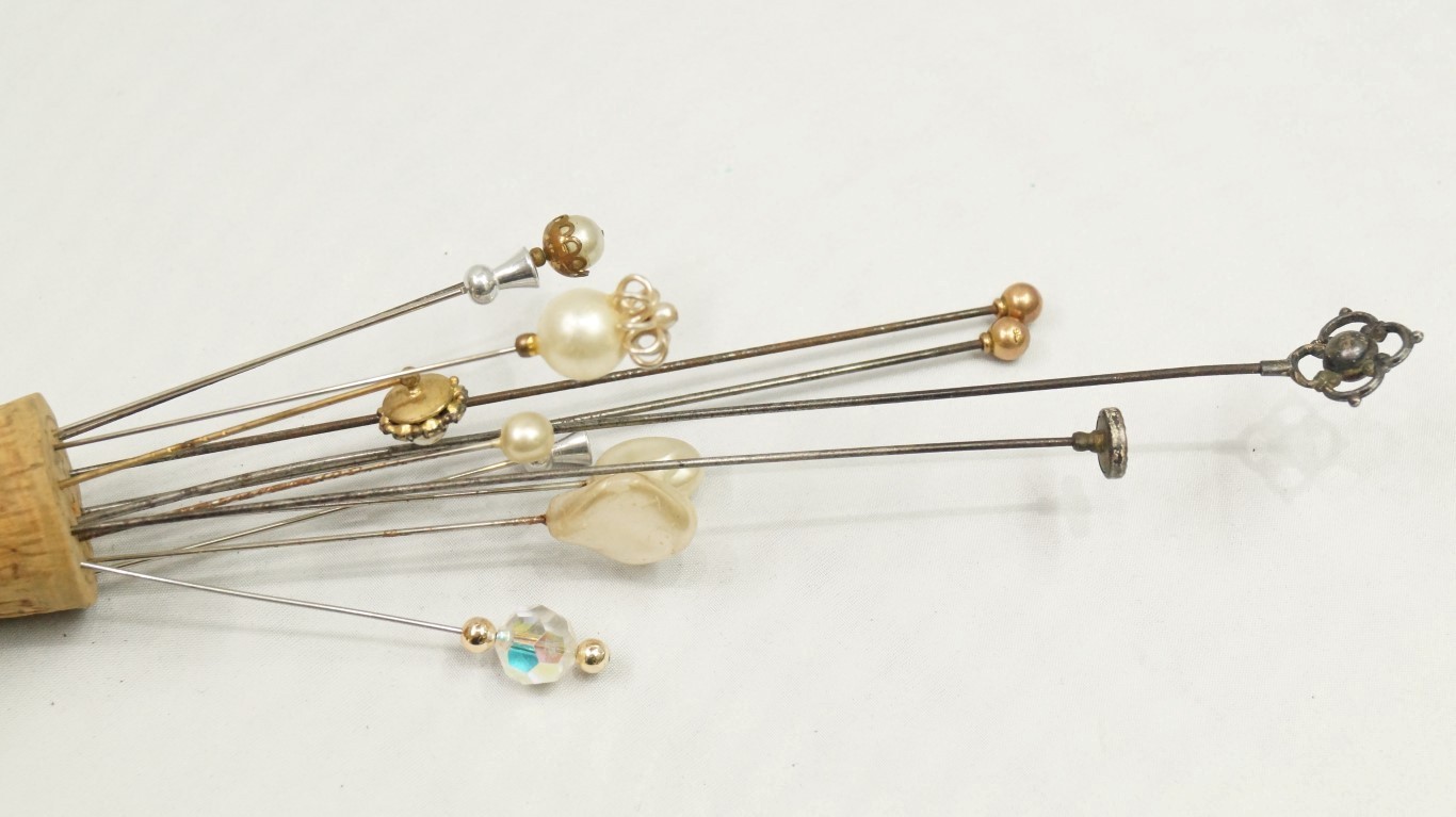 A collection of twelve various hat pins.