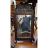 A 18th century carved walnut framed rectangular toilet mirror, the elaborate crest with shell and