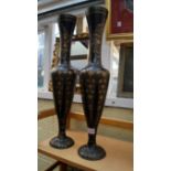 Two gilt decorated black metal vases, 56