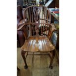 A George III yew wood and elm Windsor armchair, with pierced vase form splat and cabriole legs to