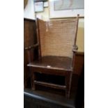 A stained pine and straw backed Orkney child's chair, labelled 'Liberty & Co'. Condition Report: