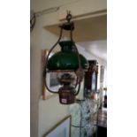 An antique brass ceiling oil lamp, with