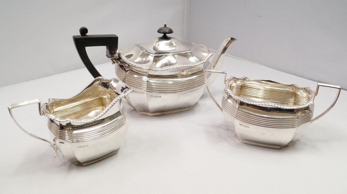 A silver three piece tea set, by James D