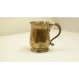 A silver christening mug, London 1920, 9cm, 190g. Condition Report: engraved initials, dented.