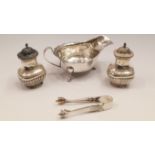 A pair of Edwardian silver pepperettes,