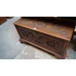 An Oriental carved camphor wood coffer,