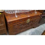 An Oriental carved camphor wood coffer,