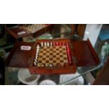 A Jaques mahogany cased travelling chess board, 15.5cm wide when closed, enclosing a set of