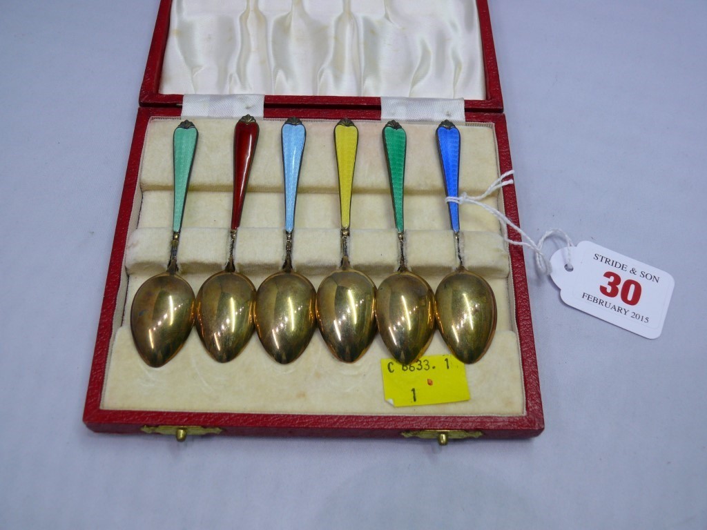 A cased set of six silver gilt and polychrome enamel coffee spoons, Birmingham 1960. Condition