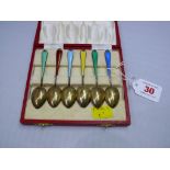 A cased set of six silver gilt and polychrome enamel coffee spoons, Birmingham 1960. Condition
