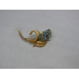 A 14k yellow metal and opal floral brooch. Condition Report: The brooch is in good order, without