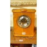 A 1930s oak mantel timepiece, with assoc