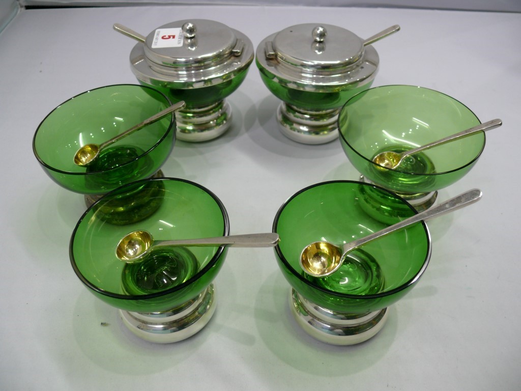 A set of six contemporary silver and green glass condiments, and matching silver gilt spoons, by