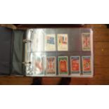 An album of 105 cigarette cards; and ass
