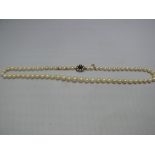 A pearl single strand necklace, having c