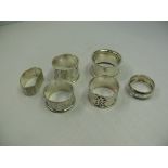 Six various silver napkin rings, 124g.
