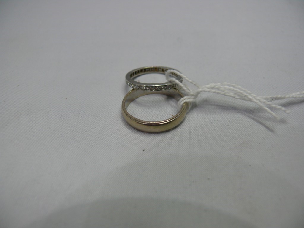 A diamond eternity ring; and a white metal wedding band. Condition Report: The eternity ring ... All - Image 2 of 2