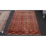 A Bokhara red and blue rug, having three