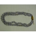 A lilac quartz two strand bead necklace,