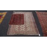 A Bokhara prayer rug, having eight small