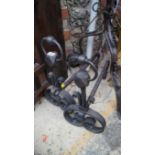 An old pair of wrought iron andirons.