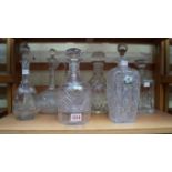 Five clear glass decanters and stoppers;
