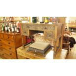 A reproduction carved oak kneehole desk,