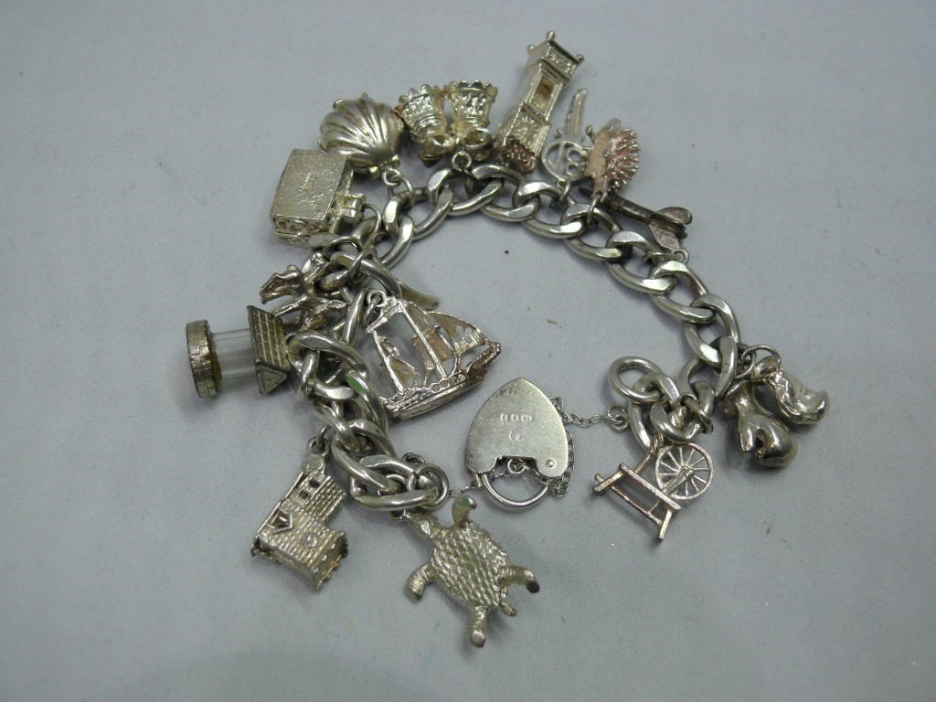 A silver charm bracelet, having fourteen