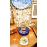 An antique brass and blue glass oil lamp