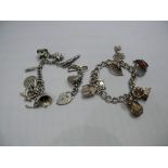 A silver charm bracelet; and another cha