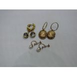 Three pairs of 9ct gold earrings.