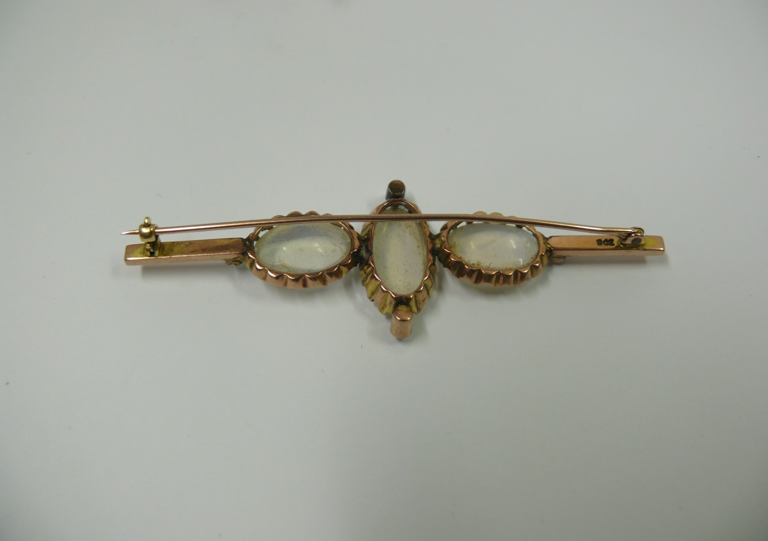 A 9ct gold bar brooch set three oval moo - Image 3 of 3