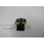 An 18ct gold sapphire and diamond ring.