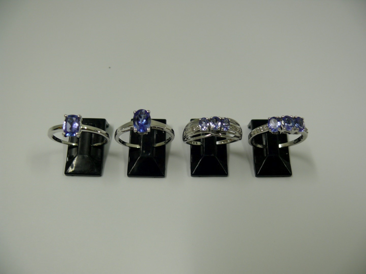 Four 10k white gold and tanzanite rings.