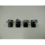 Four 10k white gold and tanzanite rings.