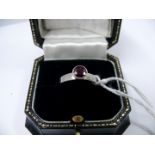 A contemporary platinum ruby solitaire r