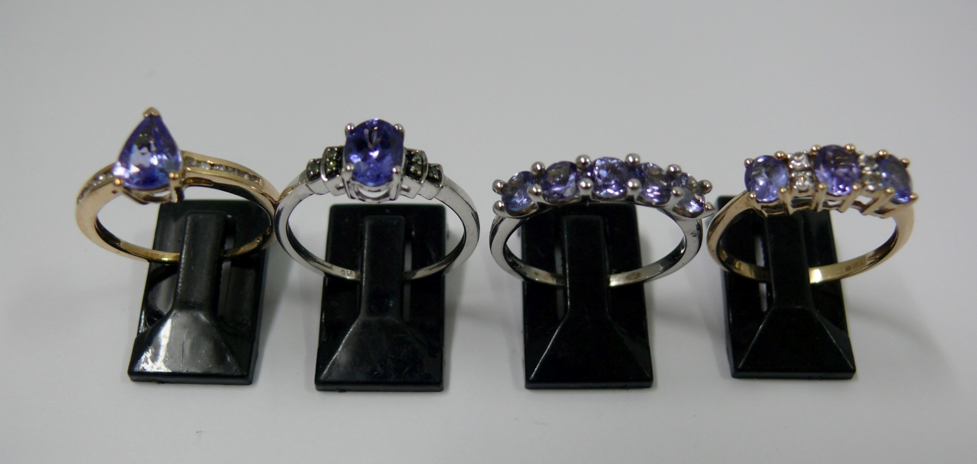 Two 9k white gold and tanzanite rings; t