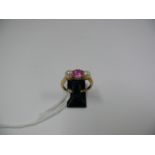 An 18ct gold ring set central pink sapphire with pearl to either side. Condition Report: Overall the