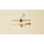 A 9ct gold bar brooch set central oval amethyst;