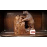 A circa 1900 Black Forest carved wood bear spill vase, 15cm high.