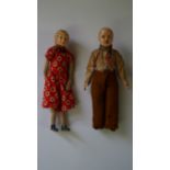A pair of WWII period German celluloid dolls, in contemporary dress, 12cm long,