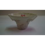 A Chinese blanc de chine libation cup, moulded in relief with flowering prunus, a deer,