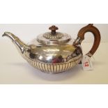 A George III silver teapot, by I.P., London 1821, of compressed spherical part fluted form, with