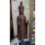 A Thai red painted and parcel gilt buddha, standing with both hands raised palms forwards,